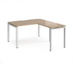 L-shaped desk with wood-effect top and white metal frame on a white background