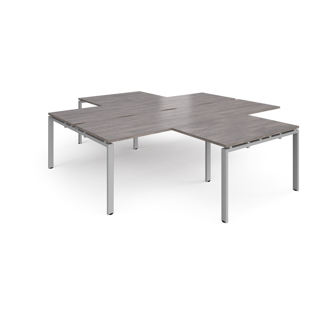 L-shaped office desks cluster with grey wood-effect top and silver metal legs on a white background