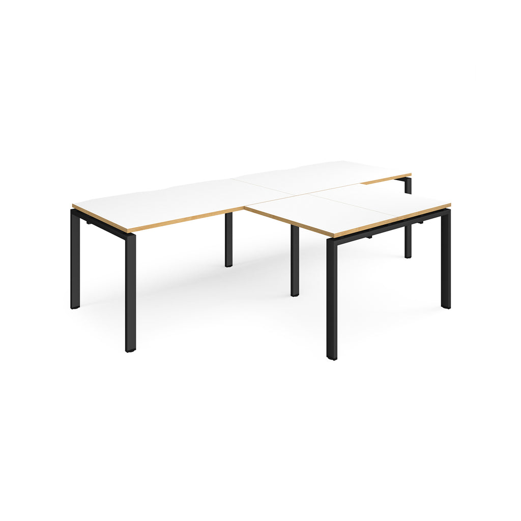L-shaped back-to-back desks with white top with wooden edges and black metal legs on a white background