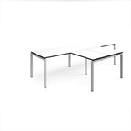 L-shaped back-to-back desks with white top with black edges and silver metal legs on a white background
