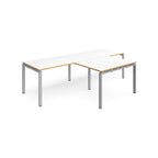 L-shaped back-to-back desks with white top with wooden edges and silver metal legs on a white background