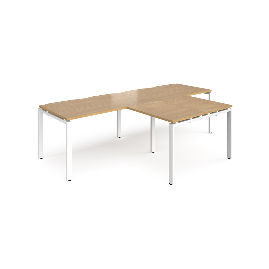 L-shaped back-to-back desks with wood-effect top and white metal legs on a white background