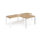 L-shaped back-to-back desks with wood-effect top and white metal legs on a white background