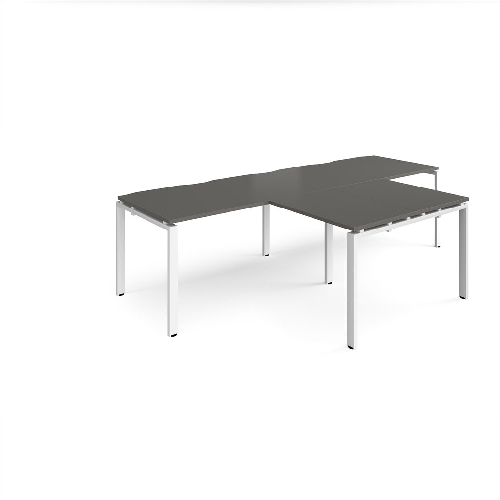 L-shaped back-to-back desks with grey top and white metal legs on a white background