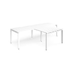 White L-shaped back-to-back desks with metal legs on a white background