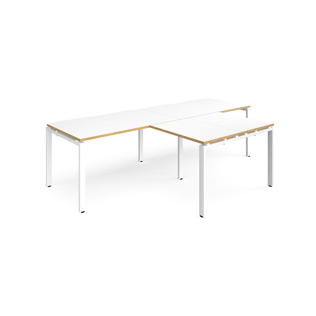 L-shaped back-to-back desks with white top with wooden edges and white metal legs on a white background