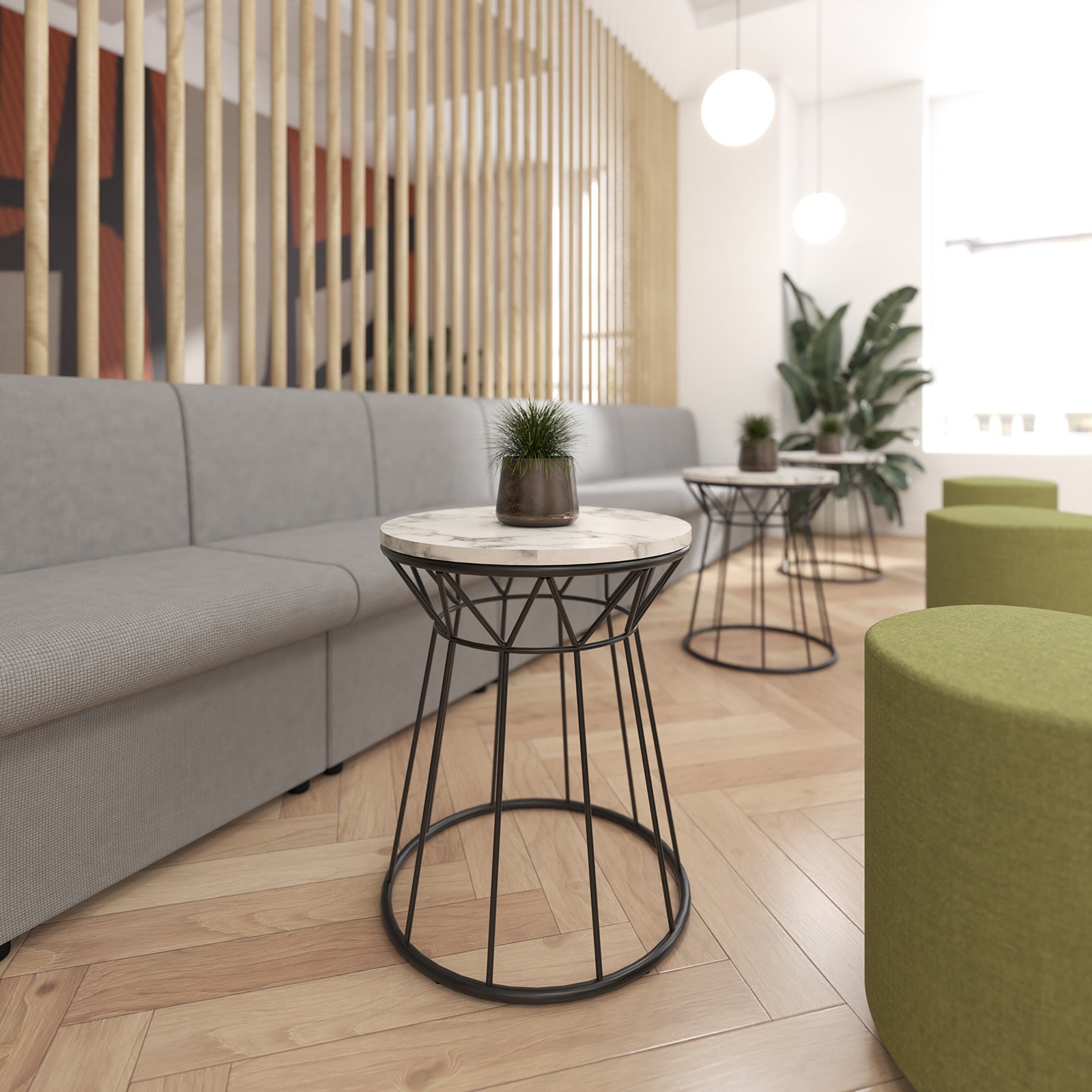 Modern interior with grey sofa, green stools, and marble-top side table.