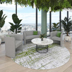 Modern furniture set with a round table and grey chairs in a room with cityscape view.