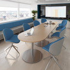 Modern conference room with a large oval table, blue chairs, and a screen displaying a presentation.