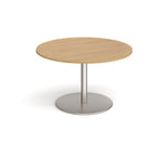 Round wooden table with metal base on a white background