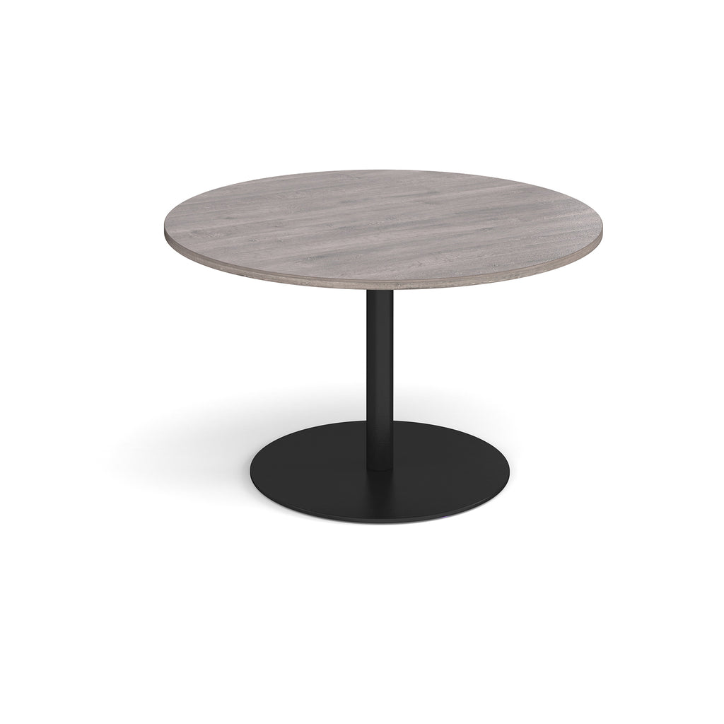 Round table with a grey top and black base on a white background