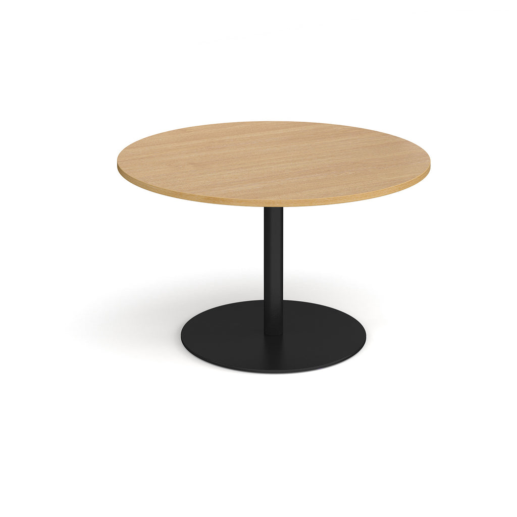 Round wooden table with a black base on a white background