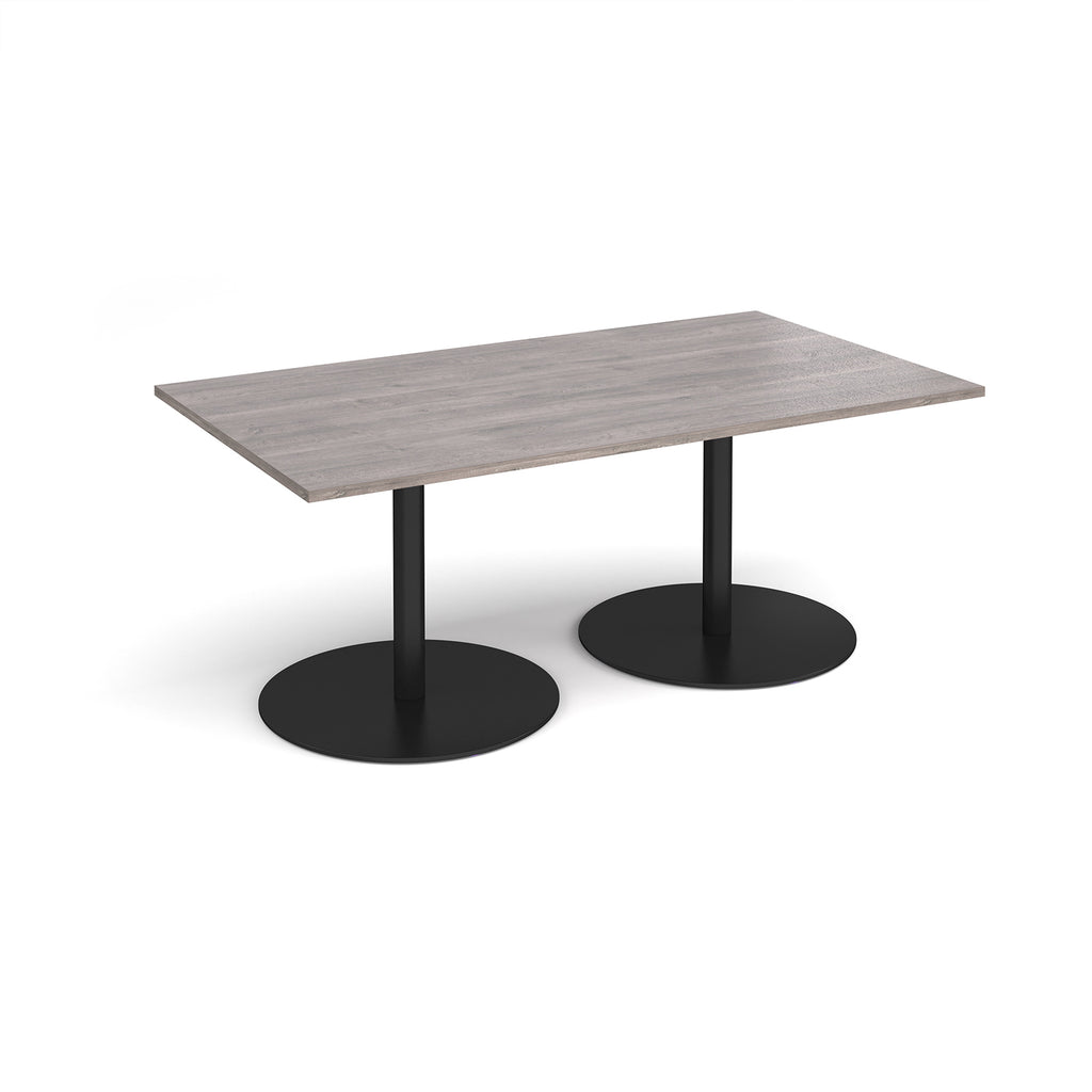A rectangular meeting table with a grey wood-effect top and two round black pedestal bases, shown on a clean white background.
