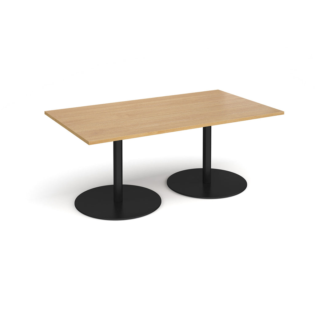 A rectangular meeting table with a wood-effect top and two round black pedestal bases, shown on a clean white background.