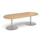 A modern oval conference table with a light oak wood-grain top and dual silver metal pedestal bases, shown on a clean white background.