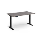 Height adjustable desk with grey wood-effect top and black metal frame on a white background