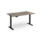 Height adjustable desk with wood-effect top and black metal frame on a white background