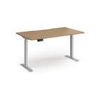 Height adjustable desk with wood-effect top and silver metal frame on a white background