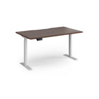 Height adjustable desk with wood-effect top and white metal frame on a white background