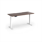 A modern height-adjustable desk with a dark brown wood-grain top and white metal legs, shown on a clean white background.