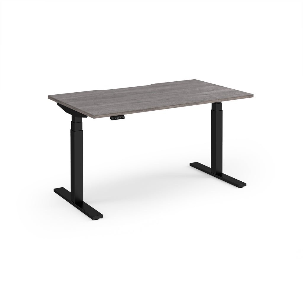 Sit-stand desk with grey wood-effect top and black legs on a white background