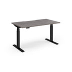 Sit-stand desk with grey wood-effect top and black legs on a white background