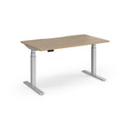 Sit-stand desk with wood-effect top and silver legs on a white background