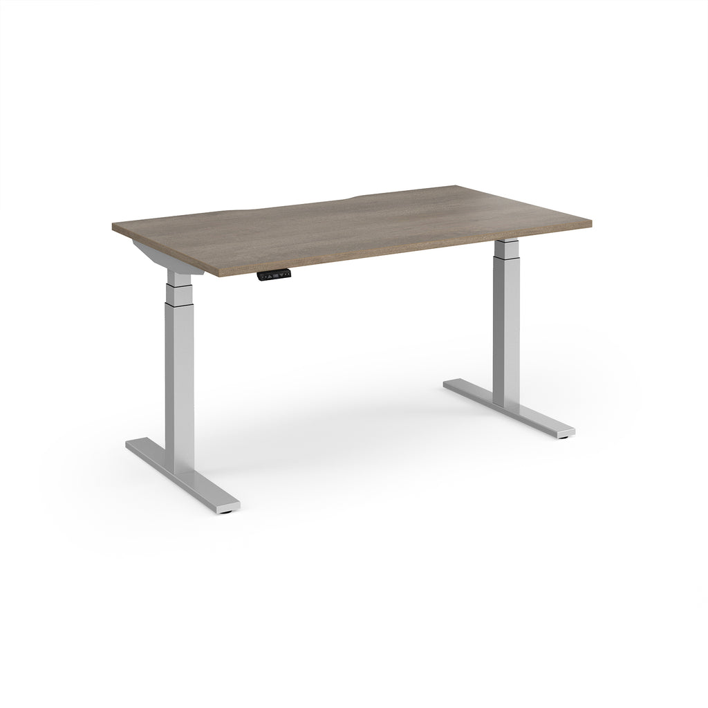 Sit-stand desk with wood-effect top and silver legs on a white background