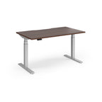Sit-stand desk with wood-effect top and silver legs on a white background