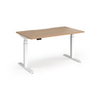 Sit-stand desk with wood-effect top and white legs on a white background