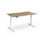 Sit-stand desk with wood-effect top and white legs on a white background