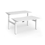Two white back-to-back height adjustable desks with shared metal frame on a white background