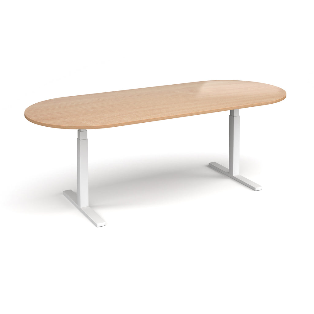 Oval height adjustable table with wood-effect top and white metal frame on a white background