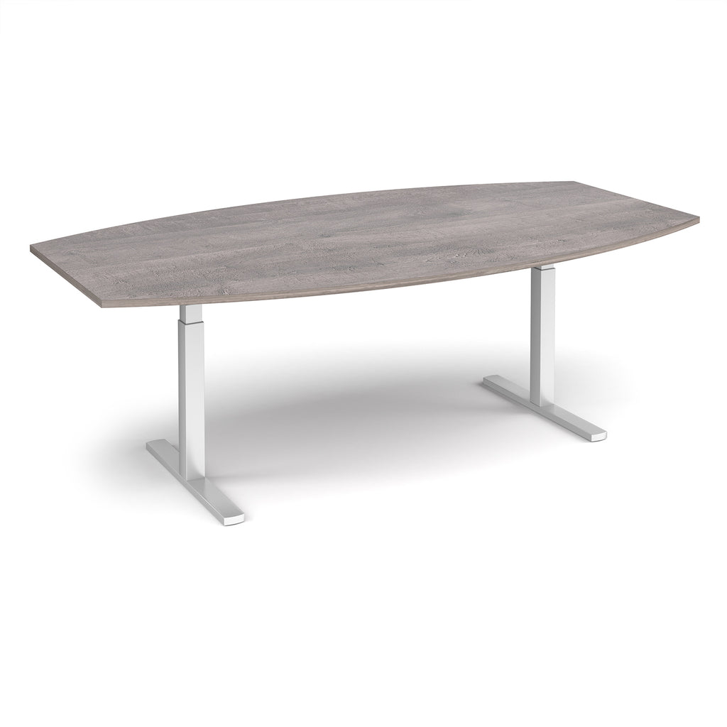 An adjustable height conference table with a grey wood grain top and silver metal pedestal legs, shown on a clean white background.