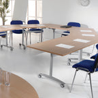 Modern conference room with hexagonal wooden tables and blue chairs.