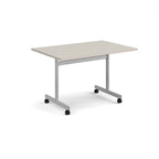 A rectangular office table with a light beige top and a silver metal frame on castors, shown on a white background.