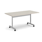 A rectangular office table with a light beige top and a silver metal frame on castors, shown on a white background.
