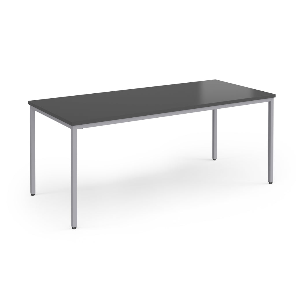 Rectangular table with a dark surface and silver legs on a white background