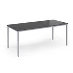 Rectangular table with a dark surface and silver legs on a white background