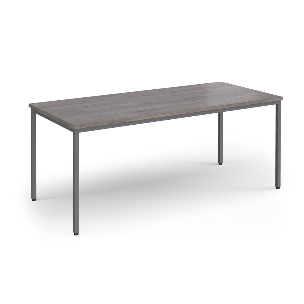 Rectangular table with a wooden top and metal legs on a white background