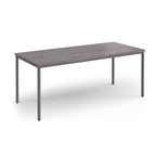 Rectangular table with a wooden top and metal legs on a white background