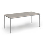 Rectangular table with a light grey surface and silver legs on a white background