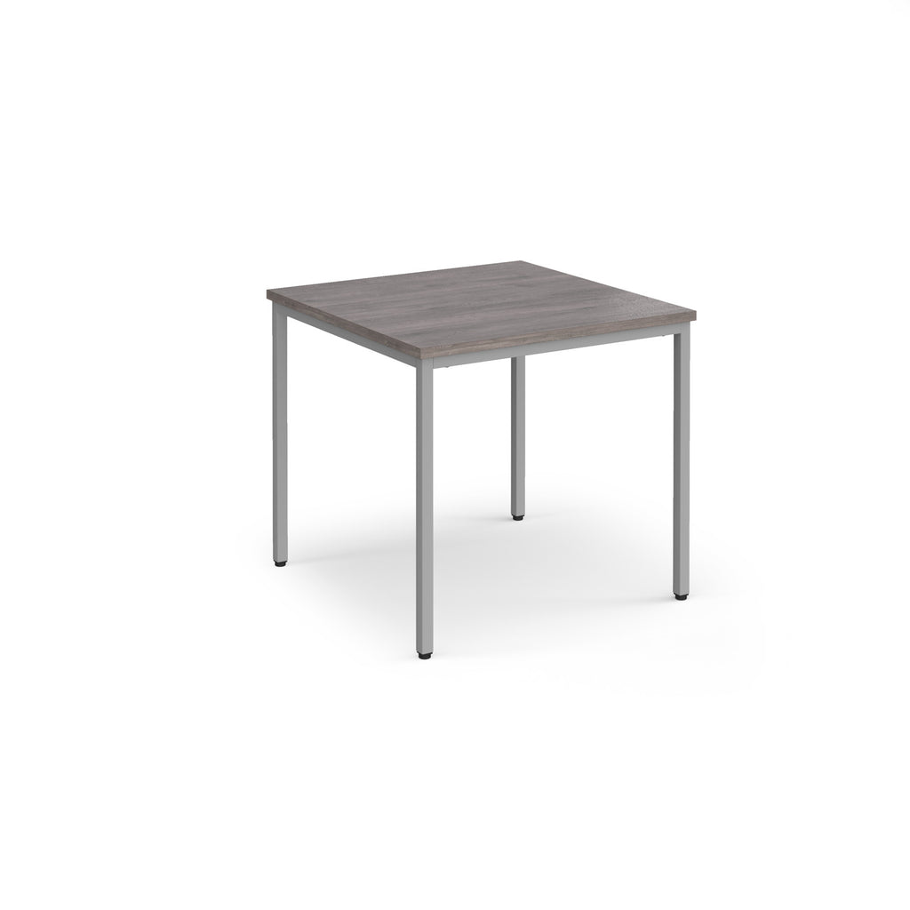 Square table with a wooden top and metal legs on a white background