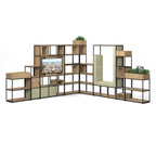 A modular modular storage unit with black metal framing, featuring open shelves, planters, a built-in TV screen, and a large panel, shown on a white background.