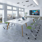 Modern office conference room with a large white table, chairs, and a wall-mounted screen displaying a colorful interface.