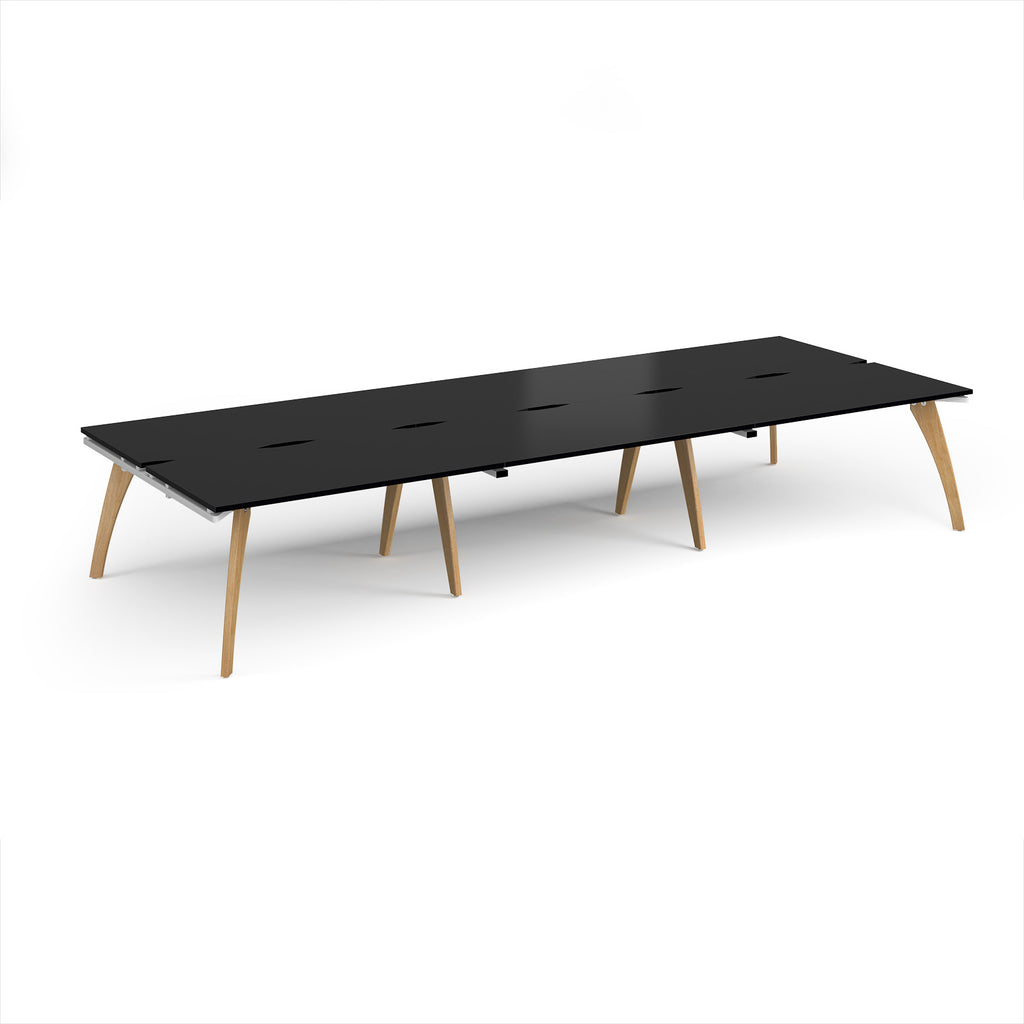 Long back-to-back wooden desk with black top on a white background