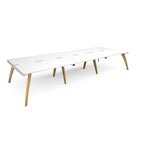 Long back-to-back wooden desk with white top on a white background