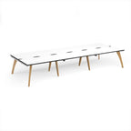 Long back-to-back wooden desk with white top with black edges on a white background