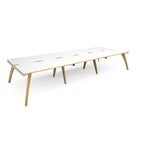 Long back-to-back wooden desk with white top with contrasting edges on a white background