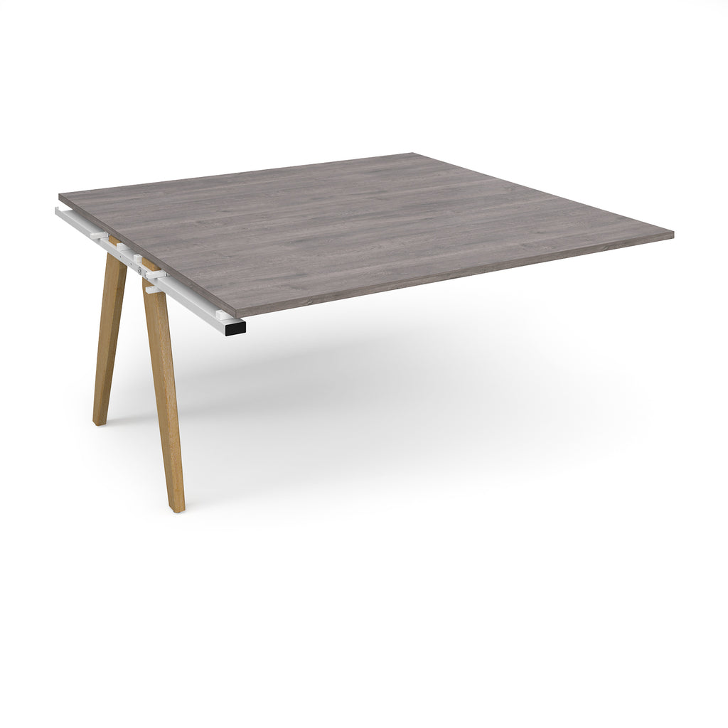 Square table add-on unit with grey wood-effect top and oak legs on a white background